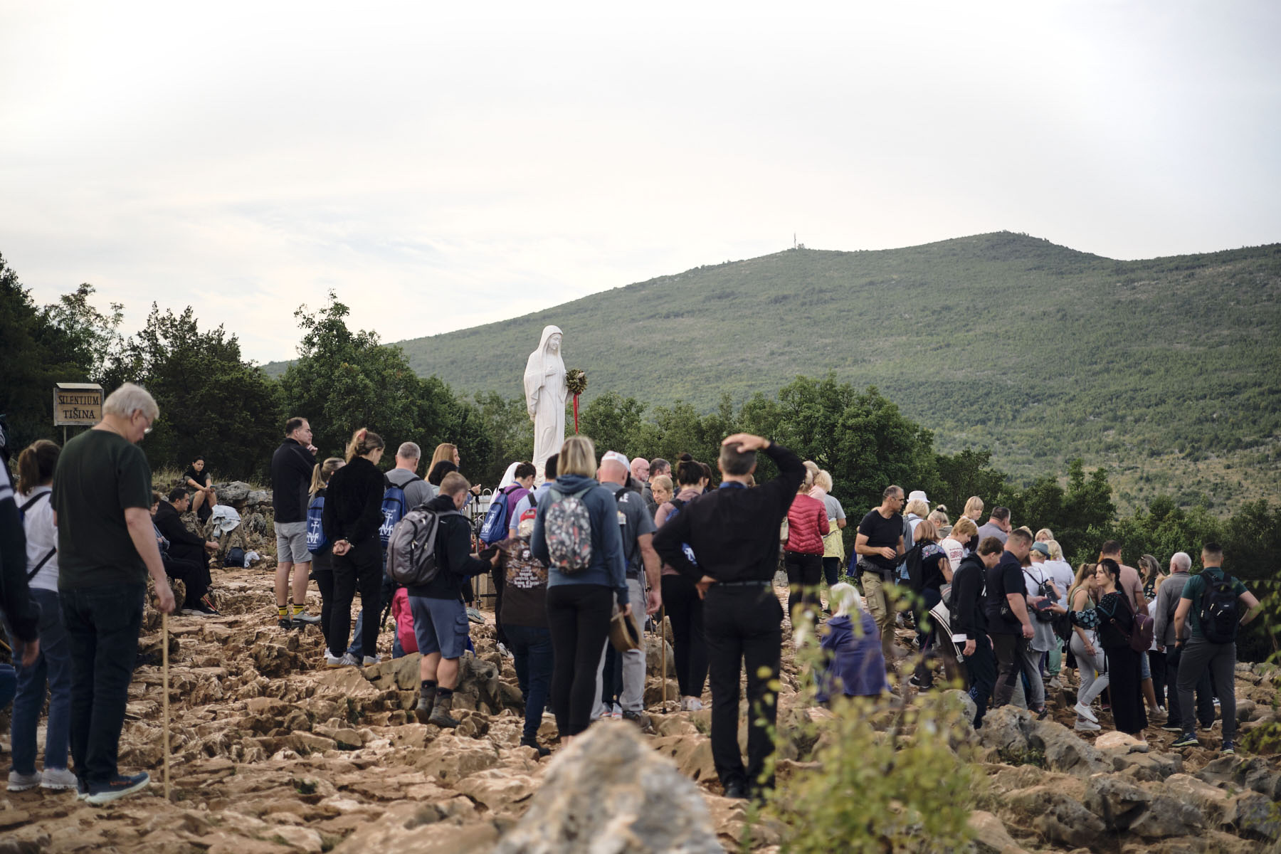 Pilgrims gathered before the statue of Our Lady on Apparition Hill
